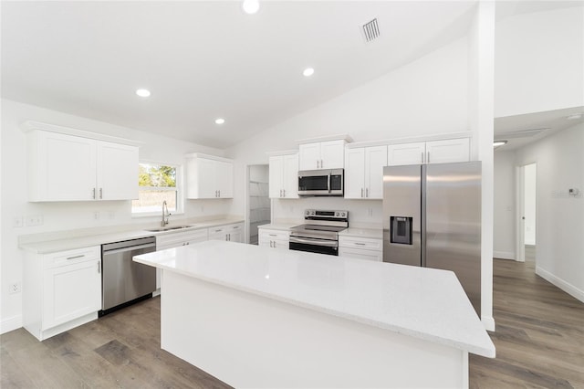 kitchen with white cabinetry, appliances with stainless steel finishes, and a kitchen island