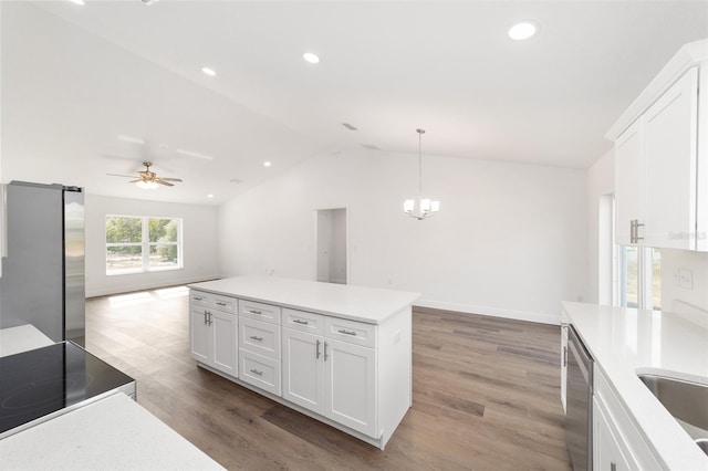 kitchen with appliances with stainless steel finishes, dark hardwood / wood-style flooring, hanging light fixtures, and white cabinets