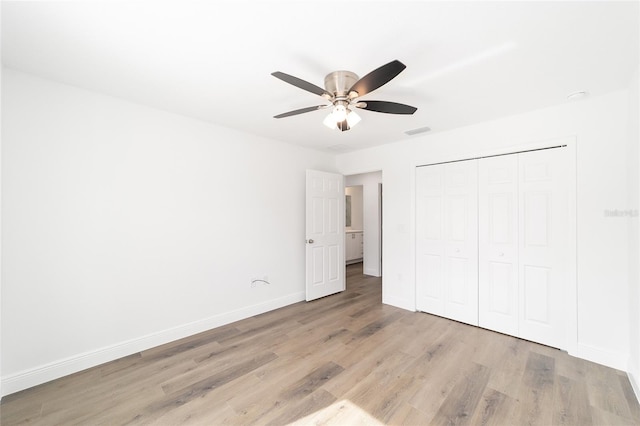 unfurnished bedroom featuring light hardwood / wood-style floors, a closet, and ceiling fan