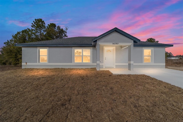 ranch-style house featuring a lawn