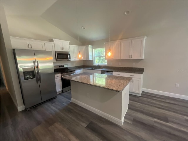 kitchen with stainless steel appliances, a center island, lofted ceiling, and white cabinetry