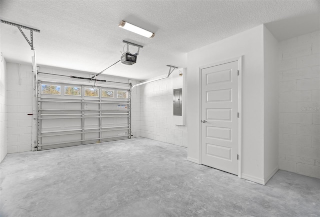 garage with a garage door opener and electric panel