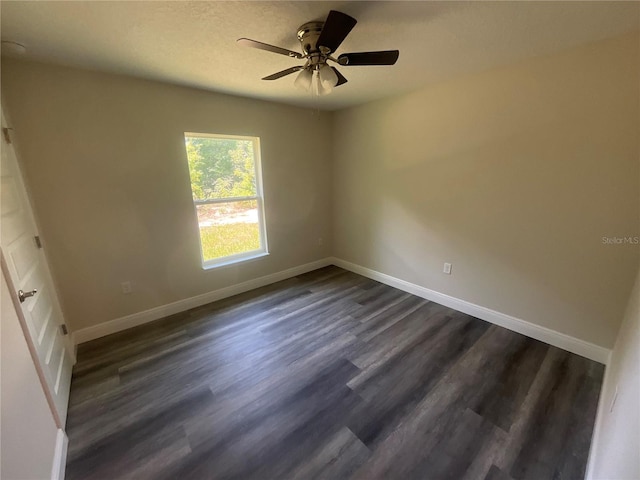 unfurnished room featuring ceiling fan and dark wood-type flooring