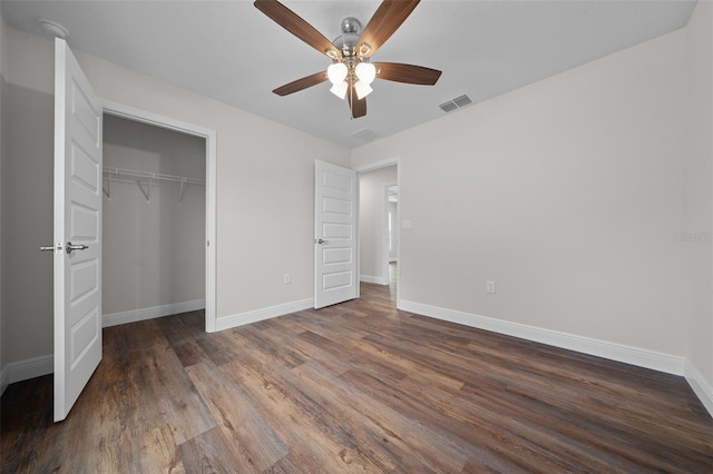 unfurnished bedroom with a closet, ceiling fan, and dark hardwood / wood-style floors