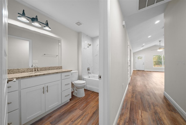 full bathroom featuring hardwood / wood-style flooring, lofted ceiling, toilet, shower / bath combination, and vanity