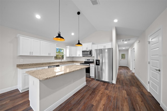 kitchen featuring appliances with stainless steel finishes, hanging light fixtures, white cabinets, a center island, and sink