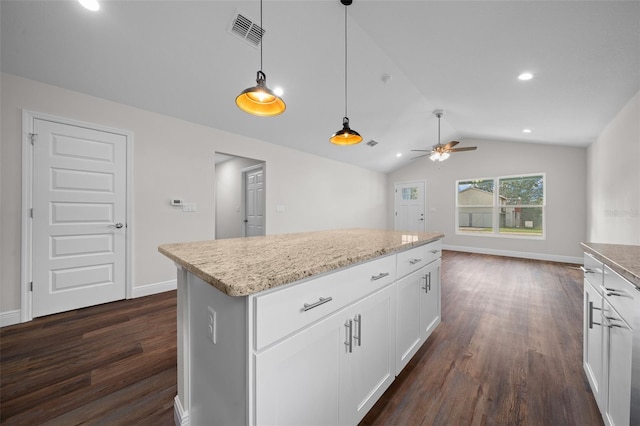 kitchen featuring hanging light fixtures, vaulted ceiling, a center island, white cabinetry, and dark hardwood / wood-style floors