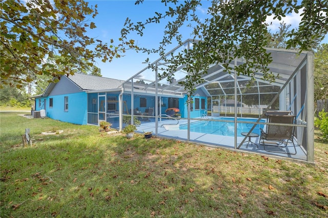 exterior space with glass enclosure, a patio area, and a lawn