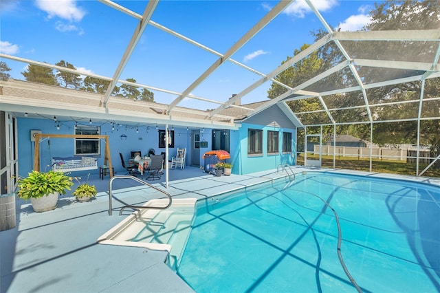 view of swimming pool with a patio and a lanai