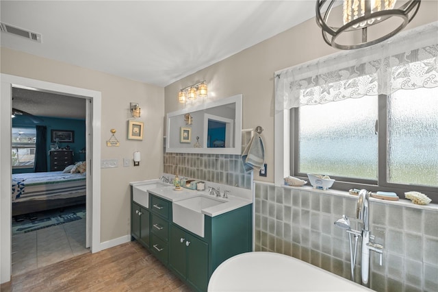 bathroom with decorative backsplash, double vanity, tile patterned flooring, and a chandelier