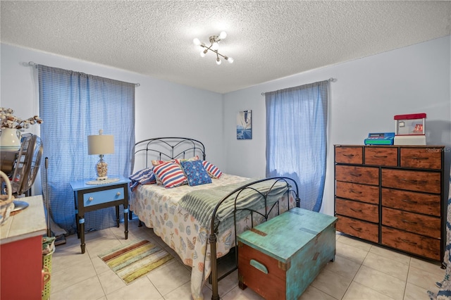 tiled bedroom featuring a textured ceiling