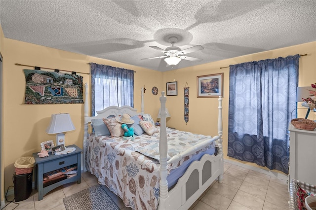 tiled bedroom with ceiling fan and a textured ceiling