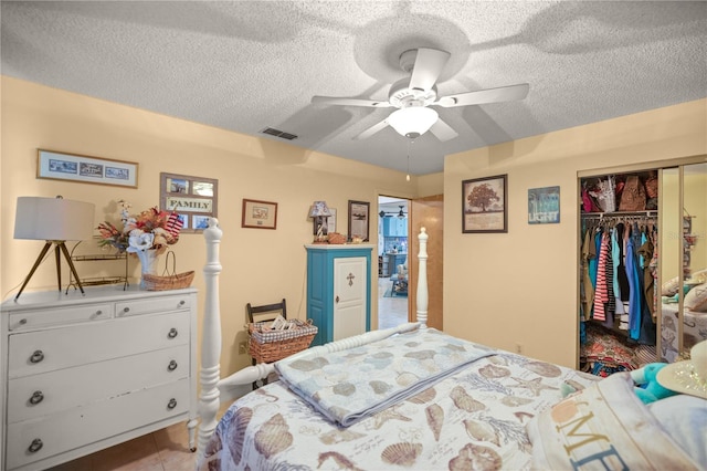 bedroom featuring a textured ceiling, a closet, and ceiling fan