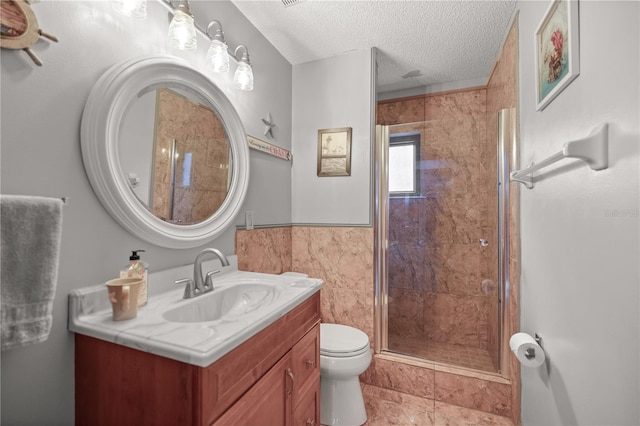 bathroom featuring tile walls, a textured ceiling, tile patterned flooring, vanity, and toilet