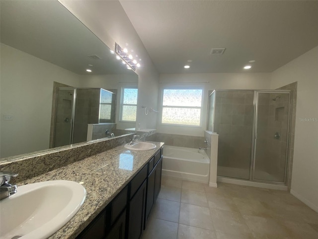 bathroom with independent shower and bath, double sink vanity, and tile patterned floors