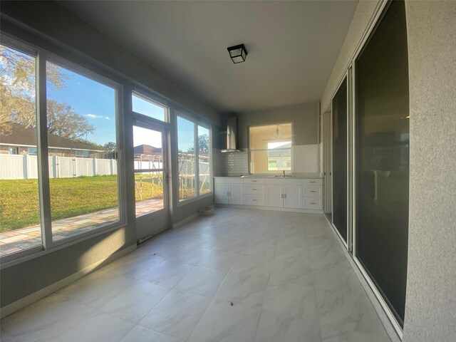 unfurnished sunroom with sink