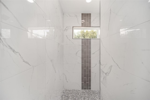 bathroom with tiled shower