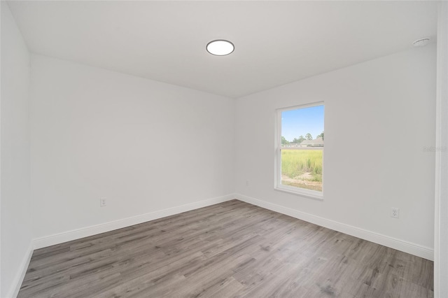 unfurnished room featuring hardwood / wood-style flooring