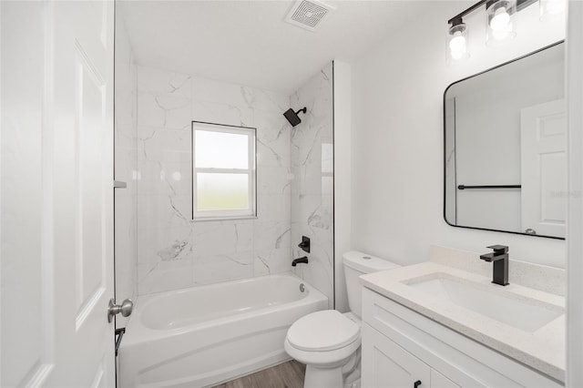 full bathroom featuring toilet, vanity, tiled shower / bath combo, and hardwood / wood-style flooring