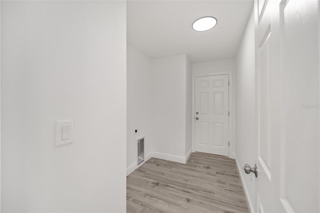 washroom with light hardwood / wood-style flooring and hookup for an electric dryer