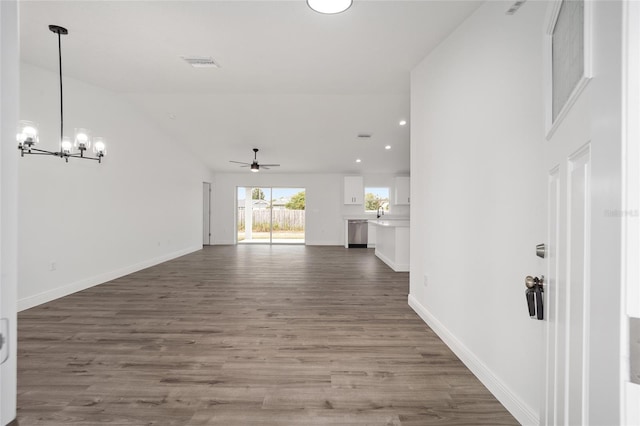 interior space with a chandelier, lofted ceiling, and dark wood-type flooring