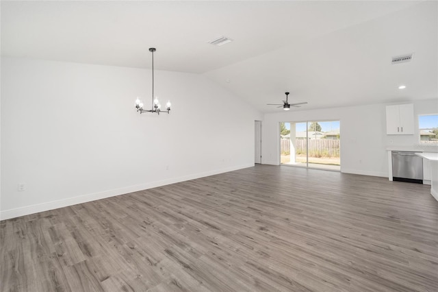 unfurnished living room with ceiling fan with notable chandelier, light hardwood / wood-style floors, and lofted ceiling