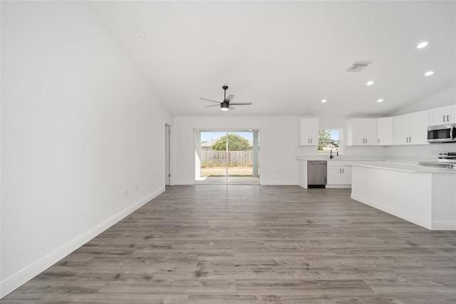 unfurnished living room featuring ceiling fan, light hardwood / wood-style flooring, and high vaulted ceiling