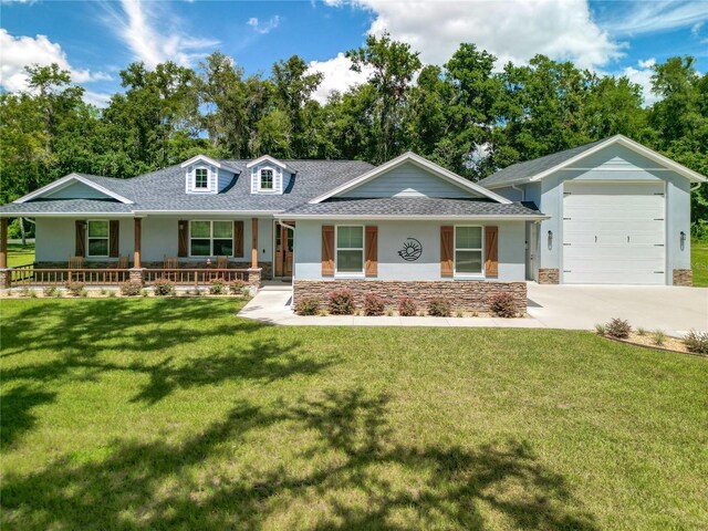 ranch-style home with a garage, a porch, and a front lawn