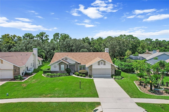 view of front of home with an attached garage, concrete driveway, and a front yard