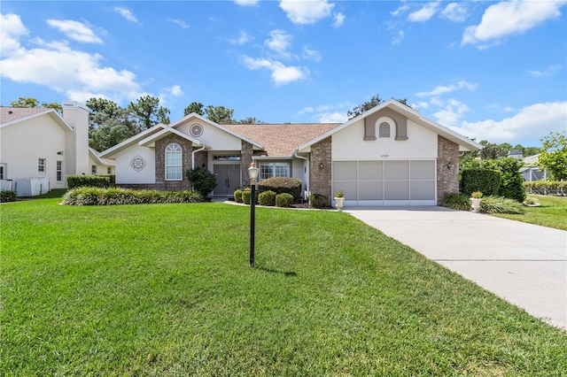 ranch-style house with driveway, a garage, brick siding, a front lawn, and stucco siding