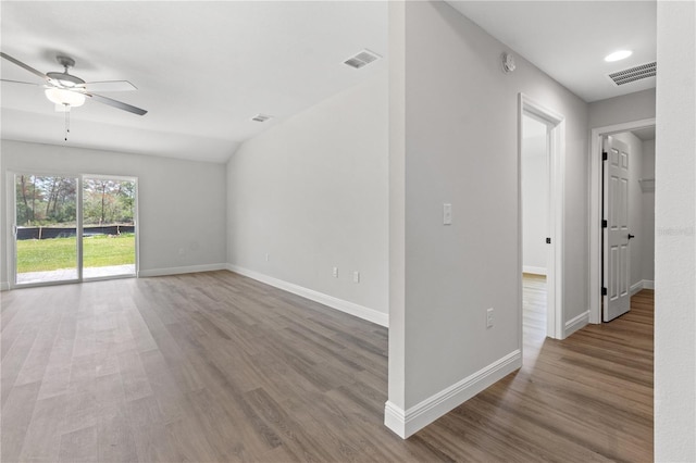 unfurnished room featuring visible vents, ceiling fan, baseboards, and wood finished floors