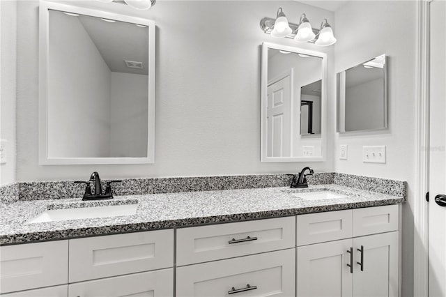 bathroom featuring a sink, visible vents, and double vanity