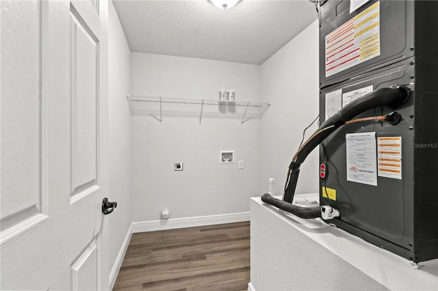 laundry area featuring hookup for a washing machine, wood finished floors, baseboards, laundry area, and a textured ceiling