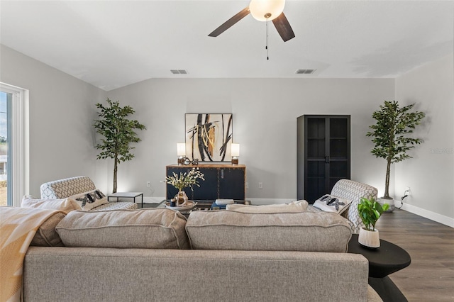 living room featuring visible vents, a ceiling fan, dark wood-style floors, baseboards, and vaulted ceiling