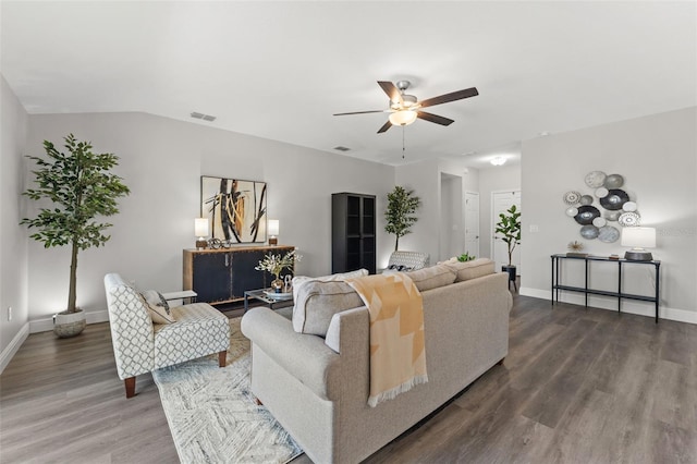 living area with baseboards, wood finished floors, visible vents, and ceiling fan