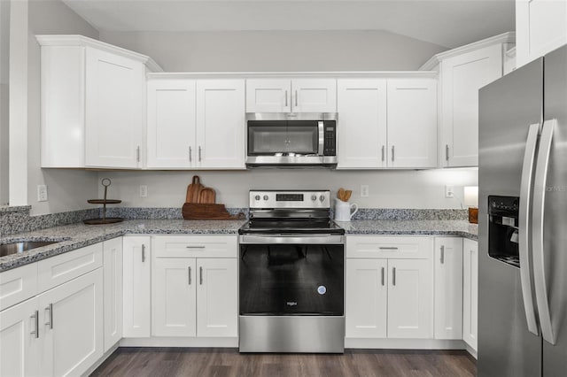 kitchen with white cabinets, stainless steel appliances, and dark wood-type flooring