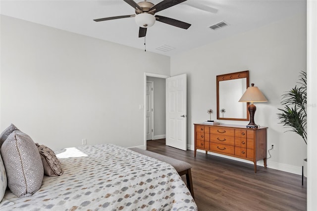 bedroom featuring visible vents, baseboards, dark wood finished floors, and a ceiling fan