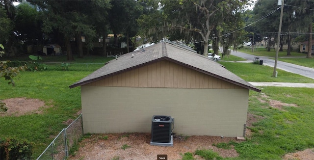 exterior space featuring a lawn and central AC unit