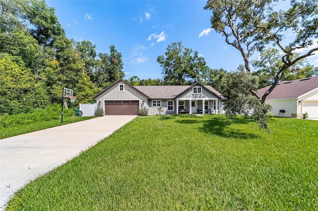 view of front of property with a front yard and a garage