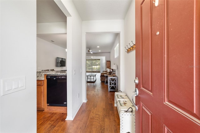 foyer entrance with ceiling fan and dark wood-type flooring