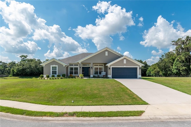 25 NW 45th Loop, Ocala, FL 34475 - view of front of home with driveway, an attached garage, fence, a front yard, and stucco siding