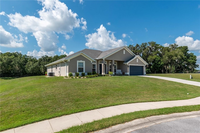 view of front of property with central AC, a garage, and a front yard