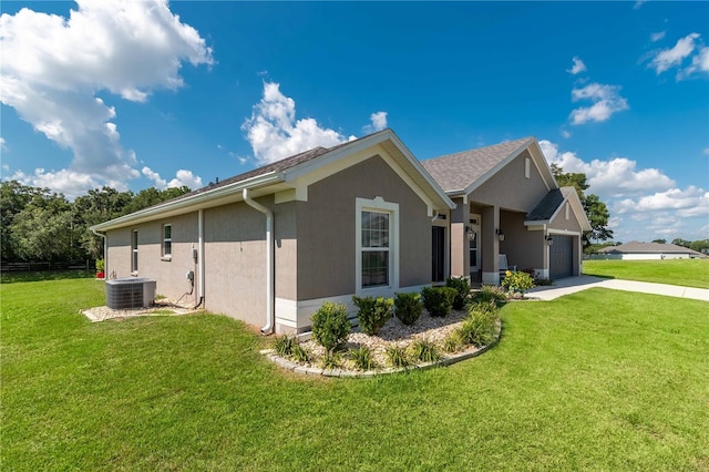 view of home's exterior with a lawn, cooling unit, and a garage