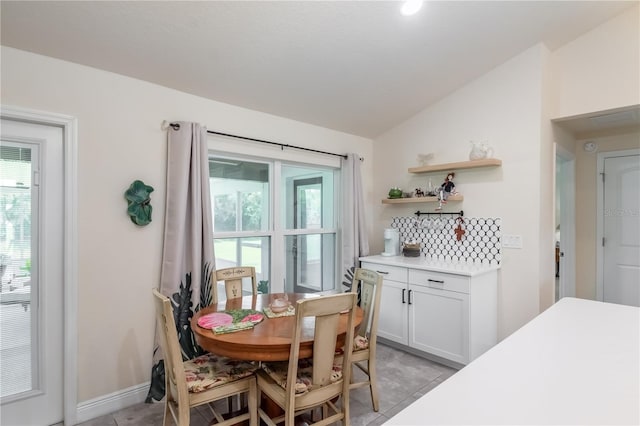 dining area with vaulted ceiling