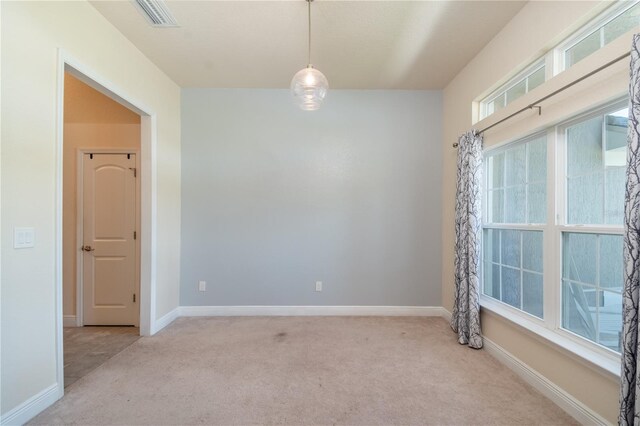 unfurnished room with plenty of natural light and light colored carpet