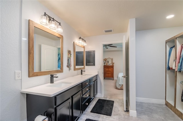 bathroom with ceiling fan and vanity