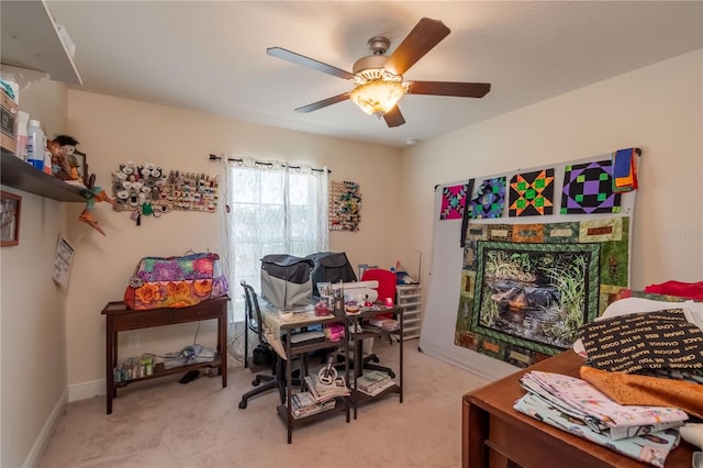 office area featuring light carpet and ceiling fan