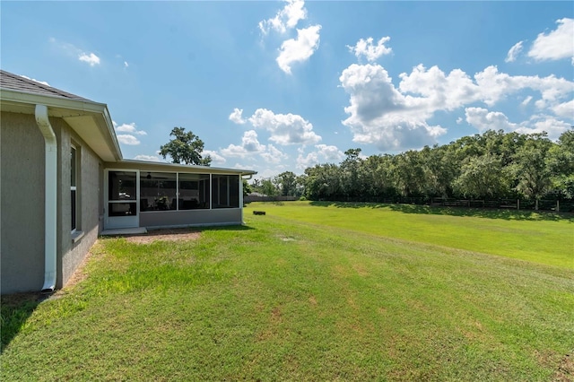 view of yard with a rural view and a sunroom