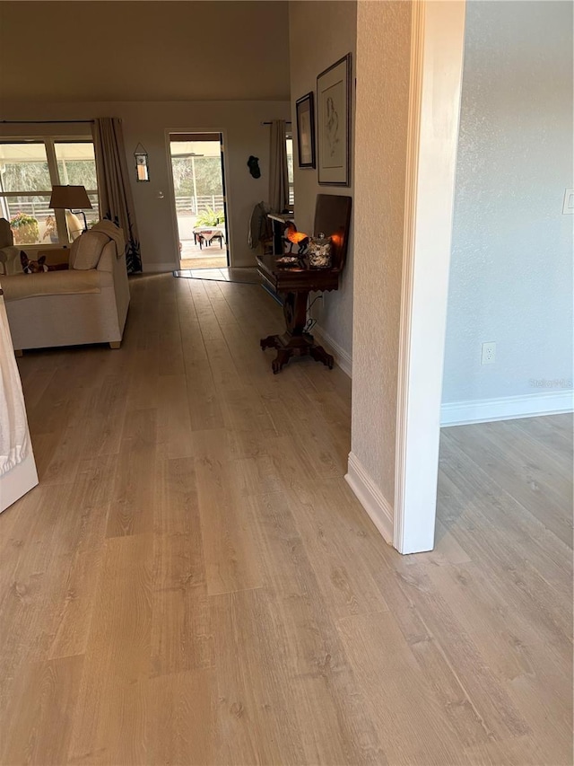 hallway with light hardwood / wood-style floors