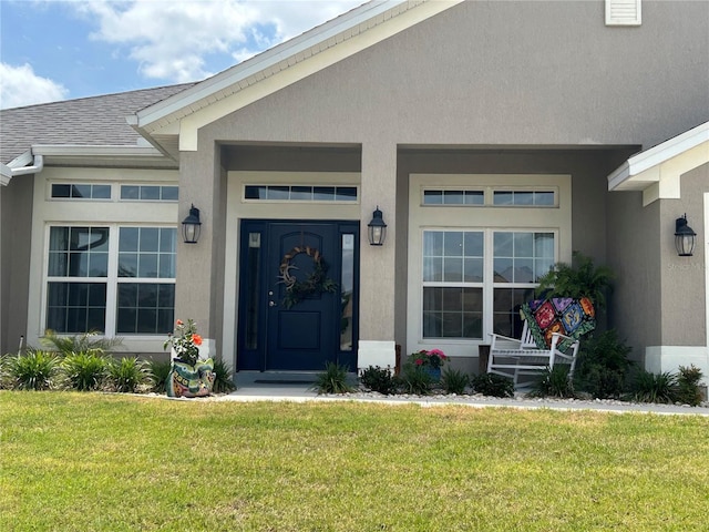 25 NW 45th Loop, Ocala, FL 34475 - entrance to property with a yard, visible vents, and stucco siding